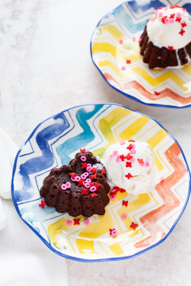 Heart Shaped Chocolate Cake from thelittlekitchen.net heart shaped chocolate cake with vanilla ice cream on a plate with another plate in the background